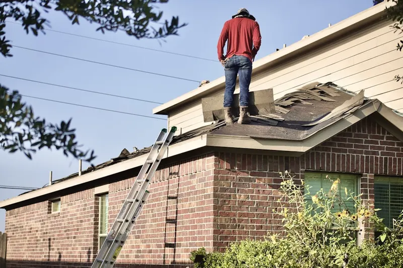 Professional roofer working on a residential roof in Fairplay